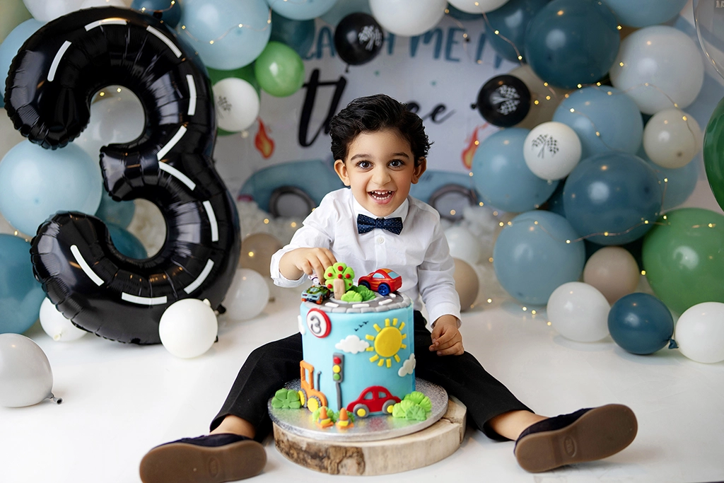Child celebrating a 3rd birthday during a cake smash photography session in Enfield, North London