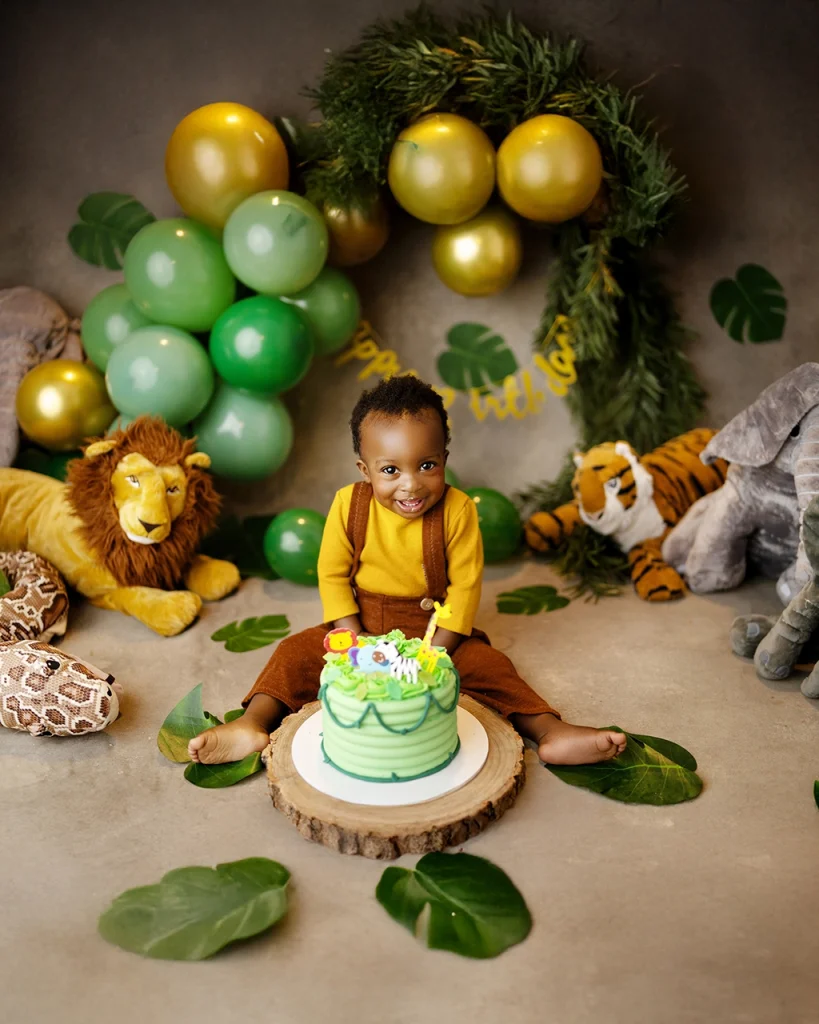 Boy celebrating his first birthday with a jungle-themed cake smash photography session in Enfield, North London