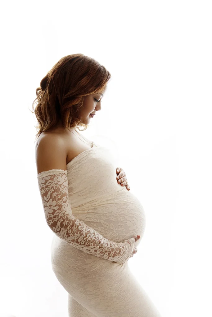 Pregnant woman in a lace maternity dress during a maternity photography session in Enfield, North London