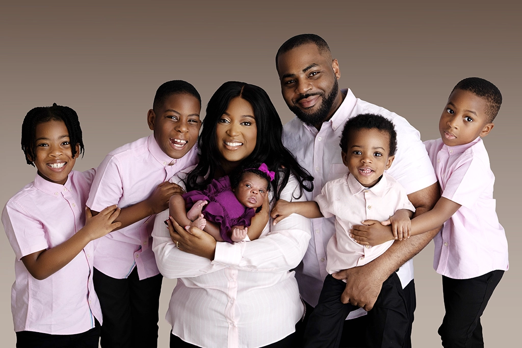 Newborn baby with parents and older siblings during a newborn family photography session in Enfield, North London