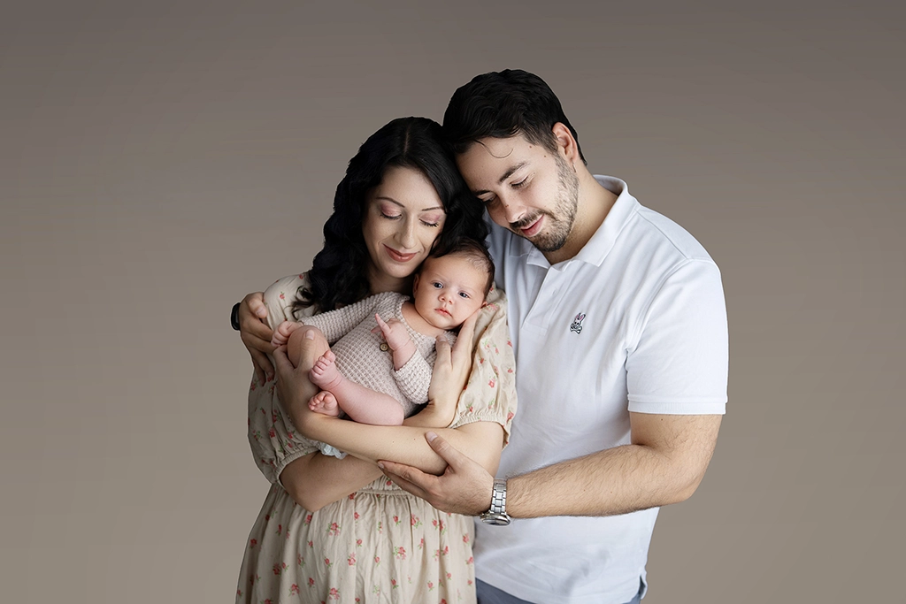 Parents holding their newborn baby during a family newborn photography session in Enfield, North London