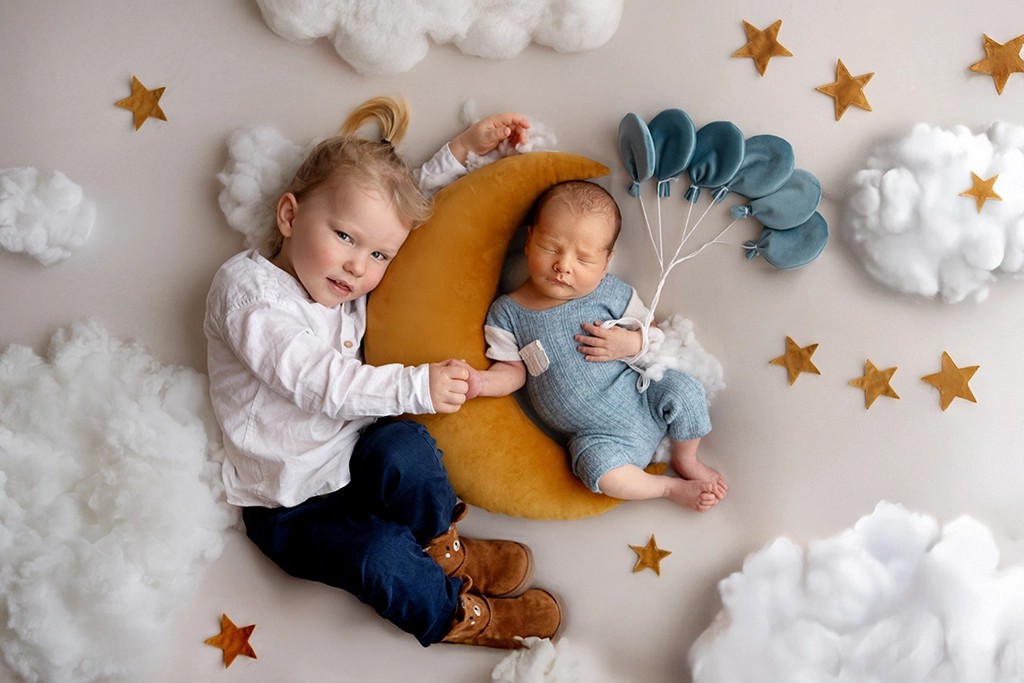 Young child photographed with newborn sibling during a newborn photography session in Enfield, North London