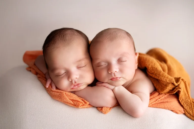 Newborn twin photography London – sleeping twins posed together during their newborn session