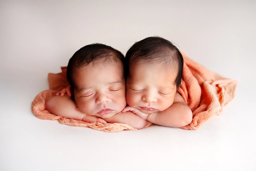 Twin newborn photoshoot in Enfield, North London – two newborn babies sleeping peacefully together