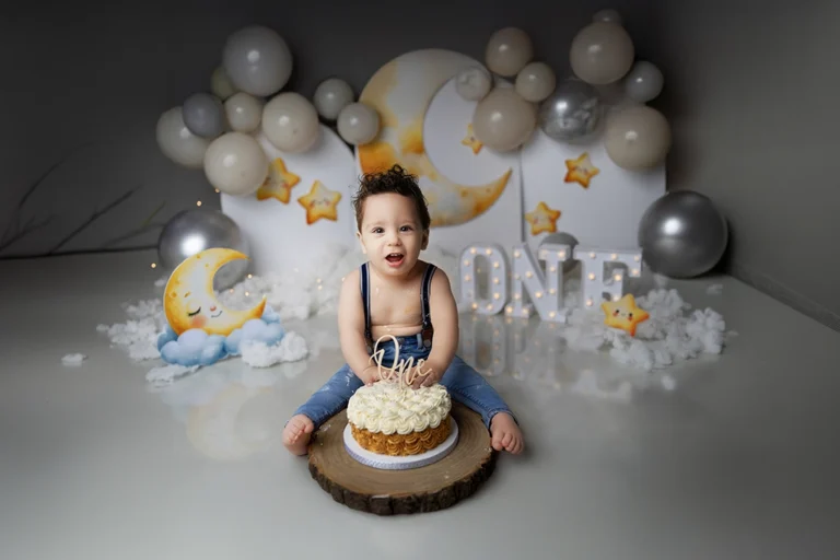 Baby celebrating a first birthday during a cake smash photography session in Enfield, North London