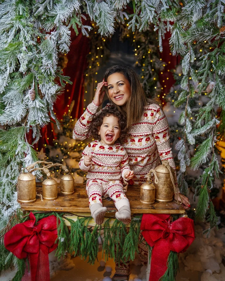 Mother and young child laughing together during a Christmas photography session in Enfield, North London