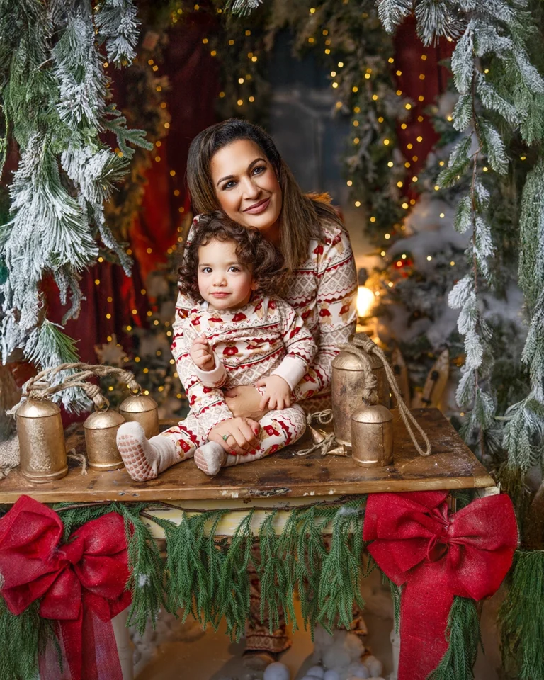 Mother holding her young child during a Christmas photography session in Enfield, North London