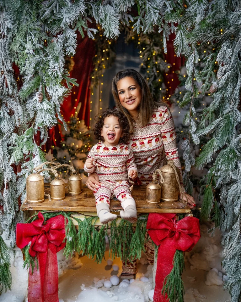 Mother and young child wearing matching festive outfits during a Christmas photography session in Enfield, North London