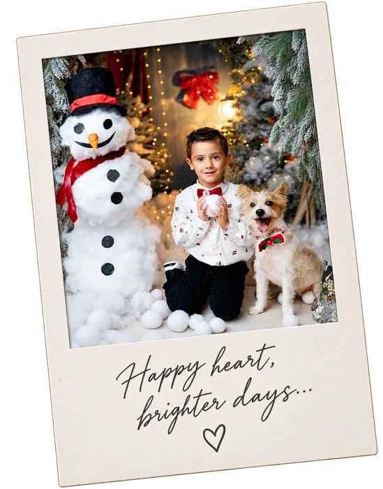 Christmas polaroid with child and dog in a snowy festive studio setting